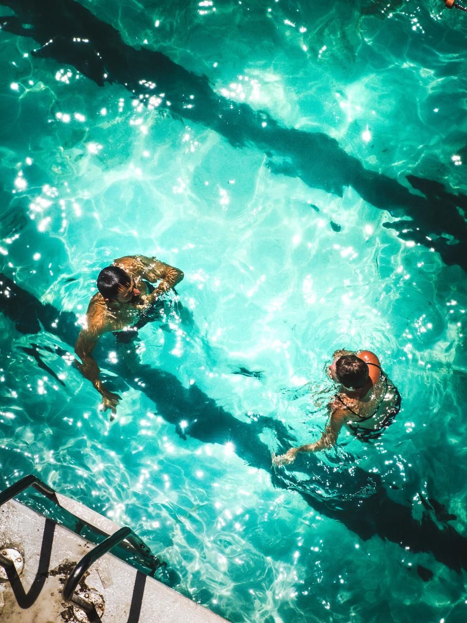 The outdoor swimming pool with loungers alongside