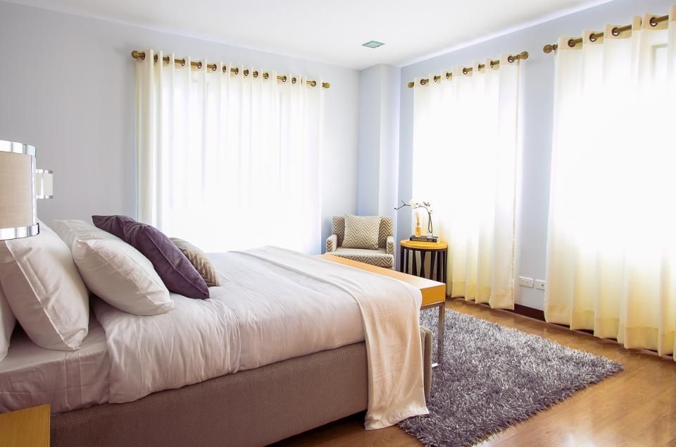 A guest room with a large bed and soft lighting